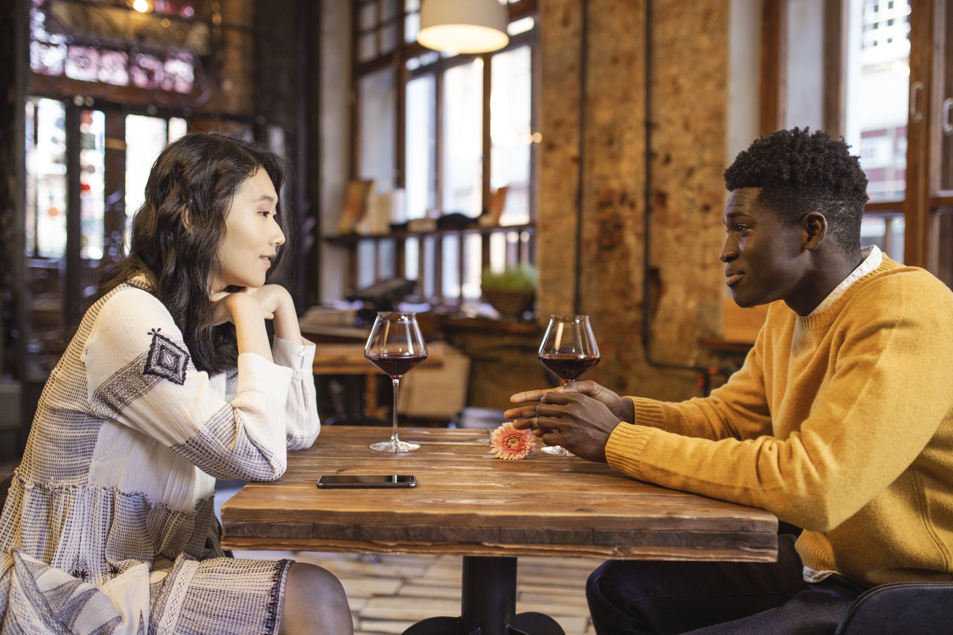 A young Asian person confidently starting a conversation on a dating app.