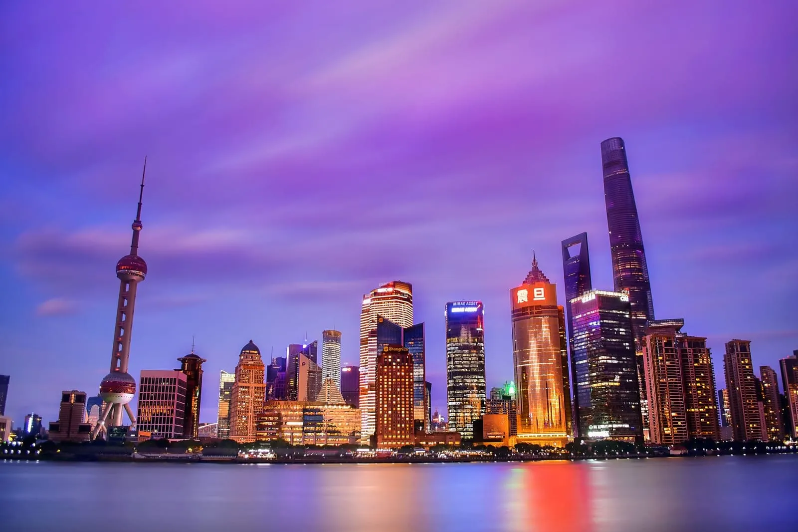 A tranquil city street blending Eastern and Western architecture at dusk.