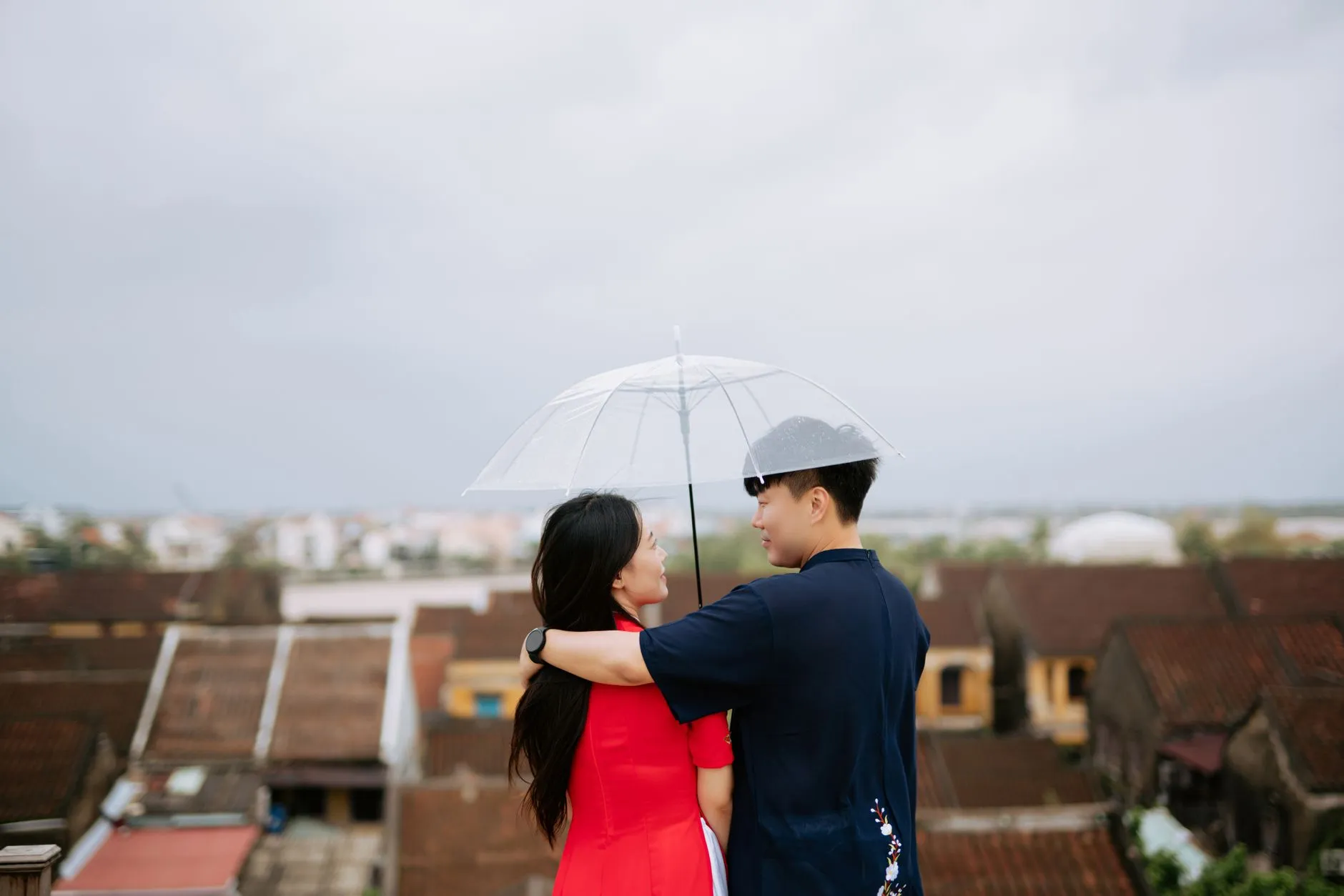 A young Asian couple walking outdoors in an urban setting