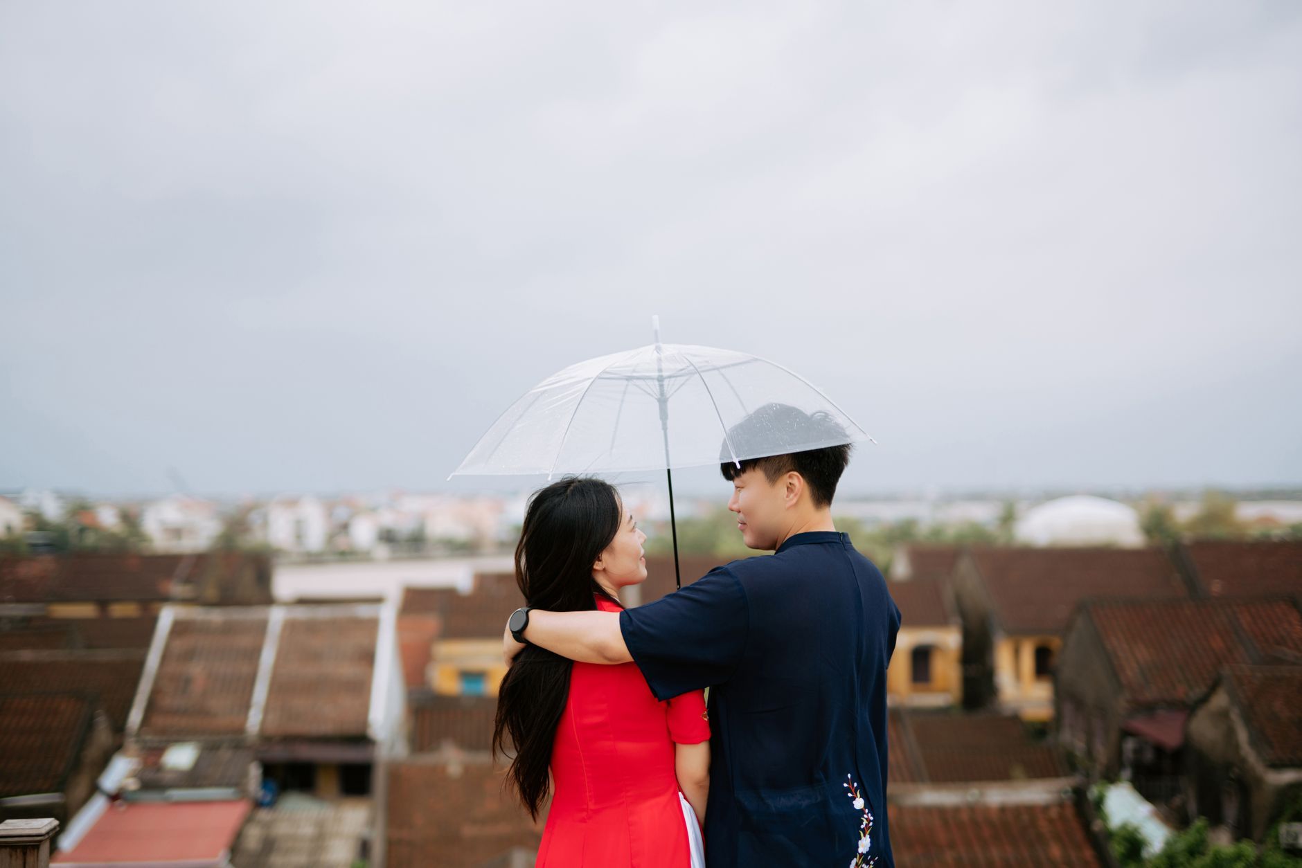A young Asian couple walking outdoors in an urban setting