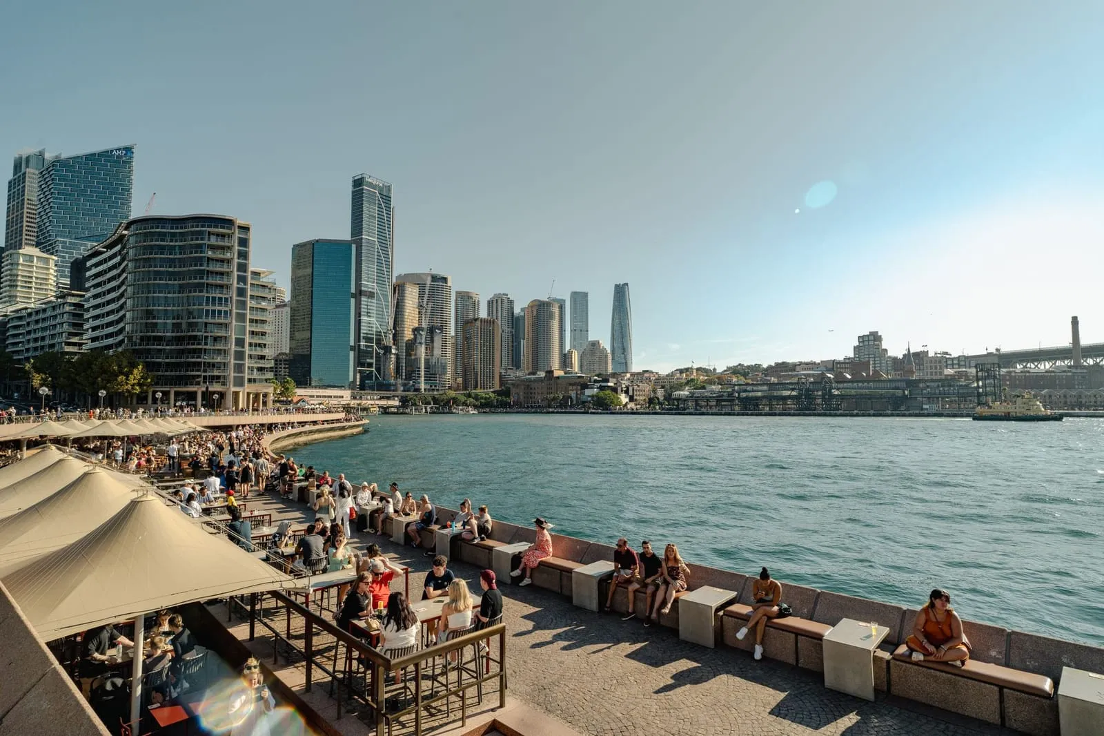 A vibrant Sydney street scene with cafes and city landmarks.