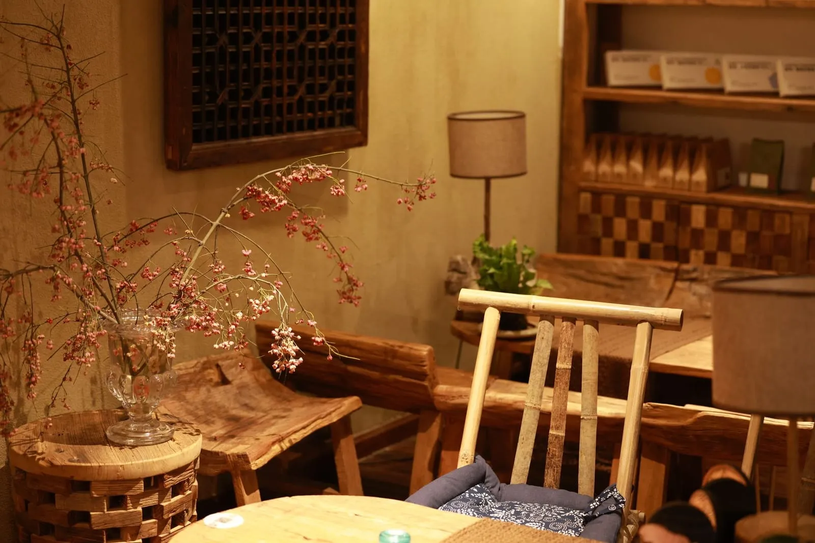 A cozy, rustic wooden café interior with warm lighting and dried blossoms—an inviting spot for a relaxed first date.