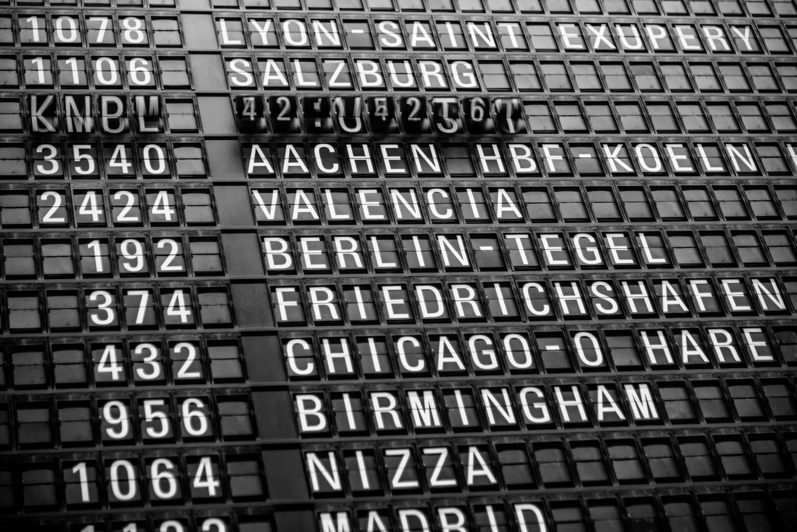 A departure board in an international airport terminal.