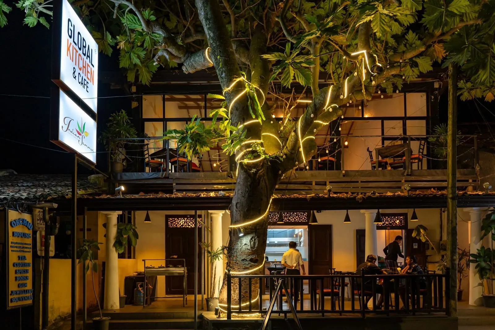 A peaceful street café at dusk in a global city symbolizing modern connection.