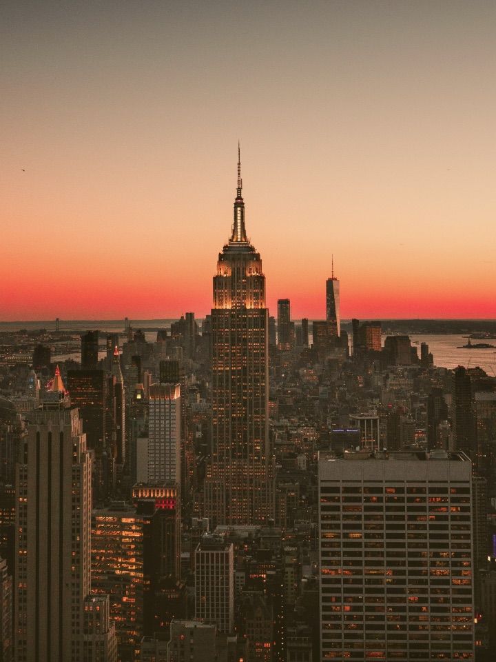 The Manhattan skyline at sunset, with the Empire State Building rising above the city