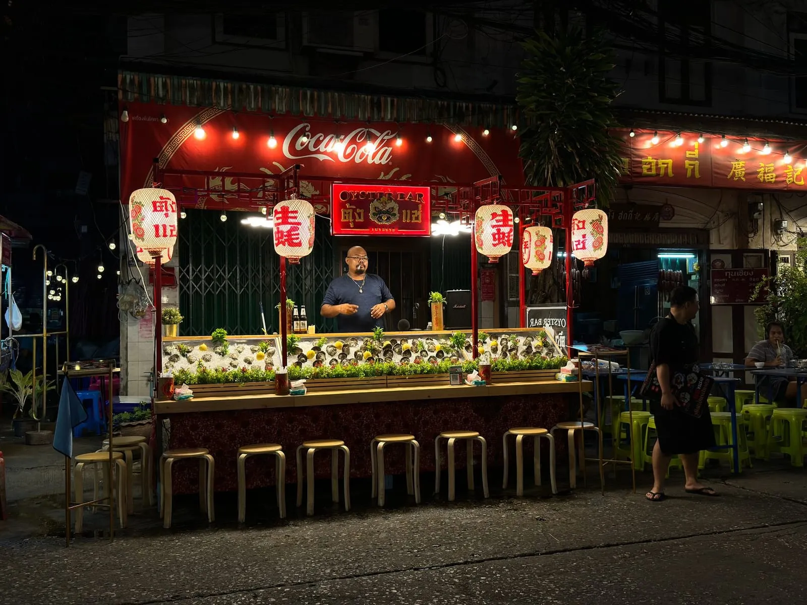 Lanterns glowing along a street in Bangkok at night