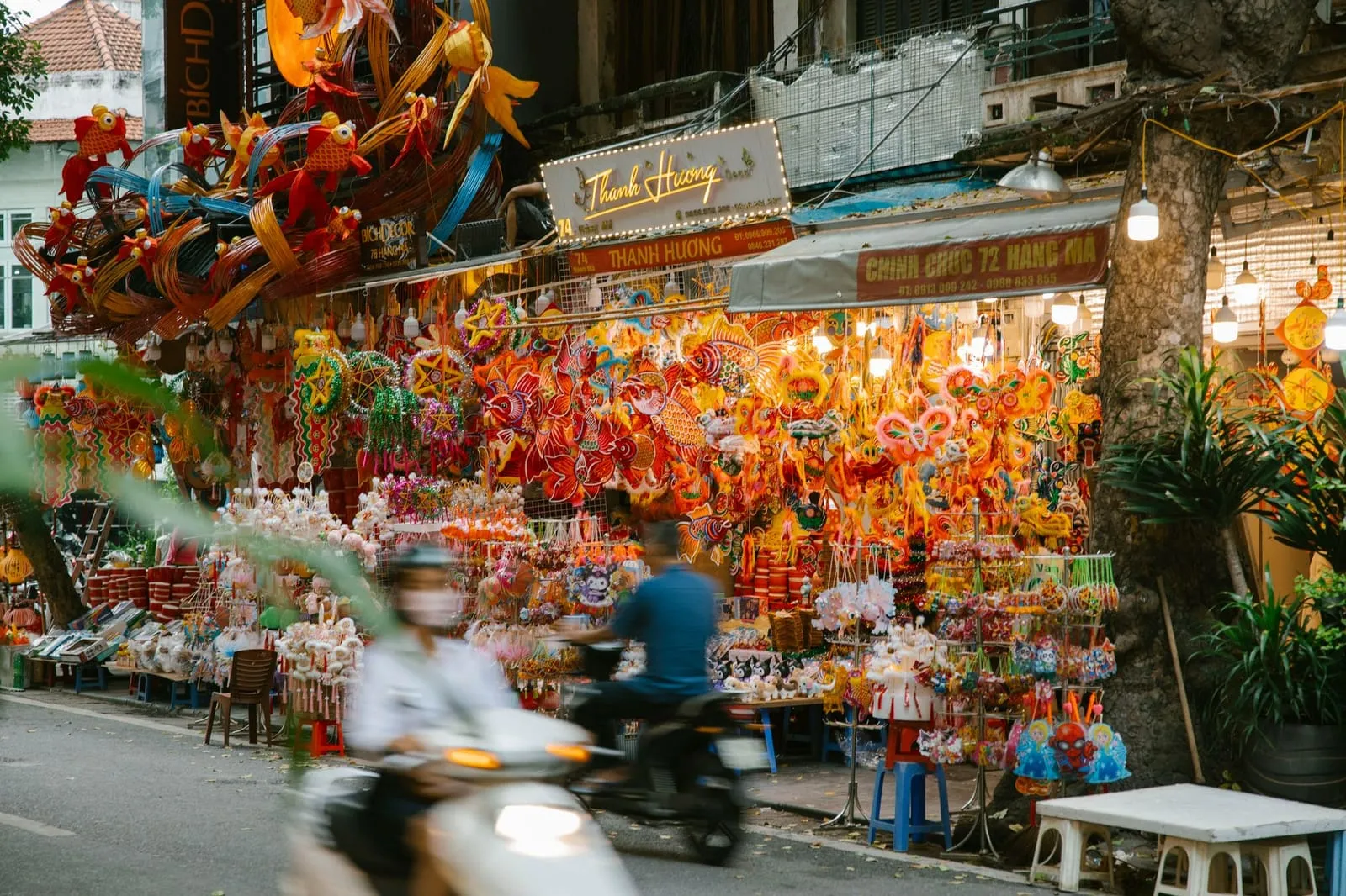 A peaceful Hanoi street with lanterns and traditional architecture at dusk.